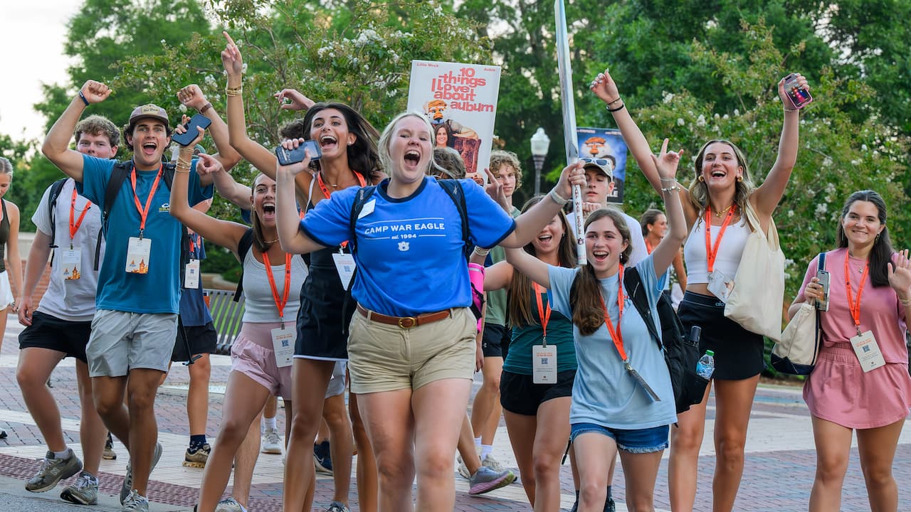 Camp War Eagle counselor walking with group of students